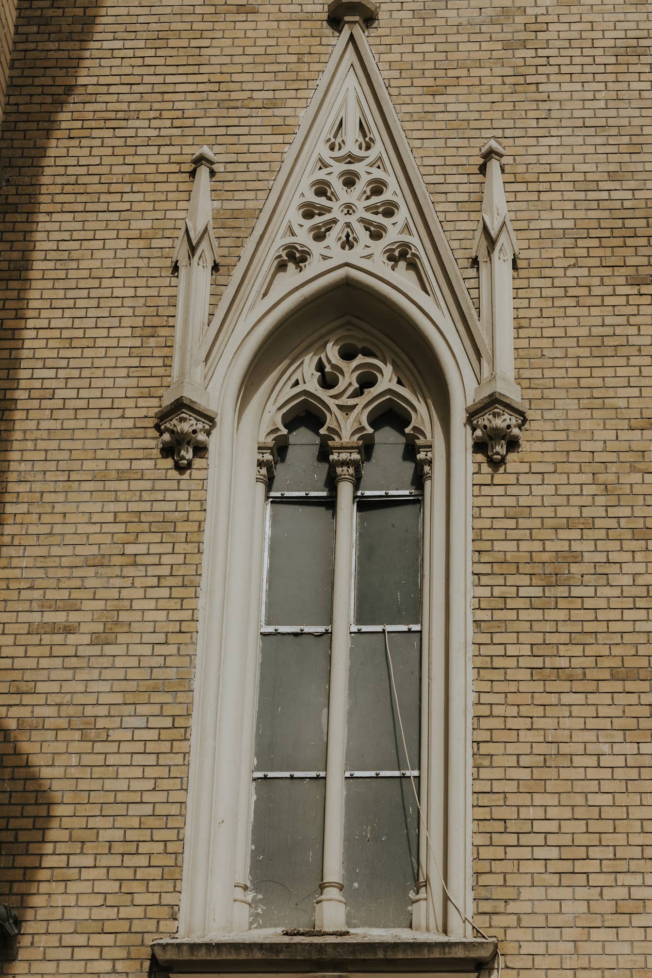 Gothic ornaments on window on brick wall catholic cathedral