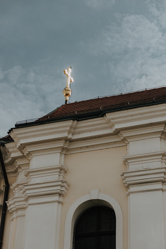 Golden glow cross on roof of church