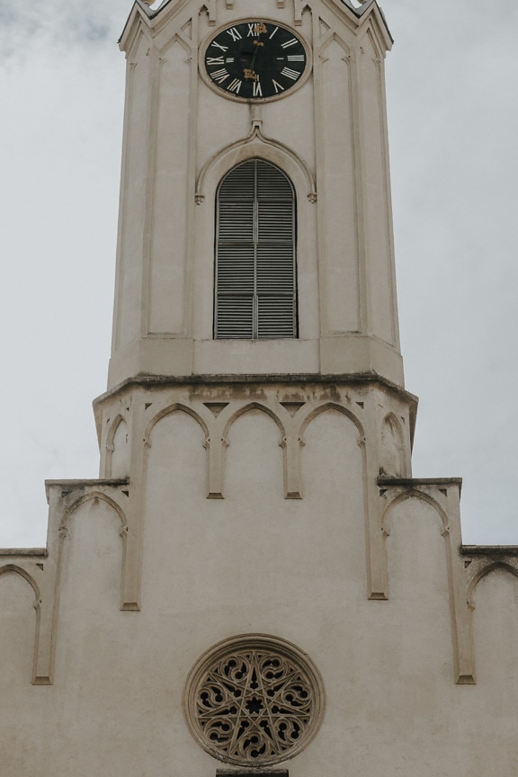 Catholic church tower with analog clock