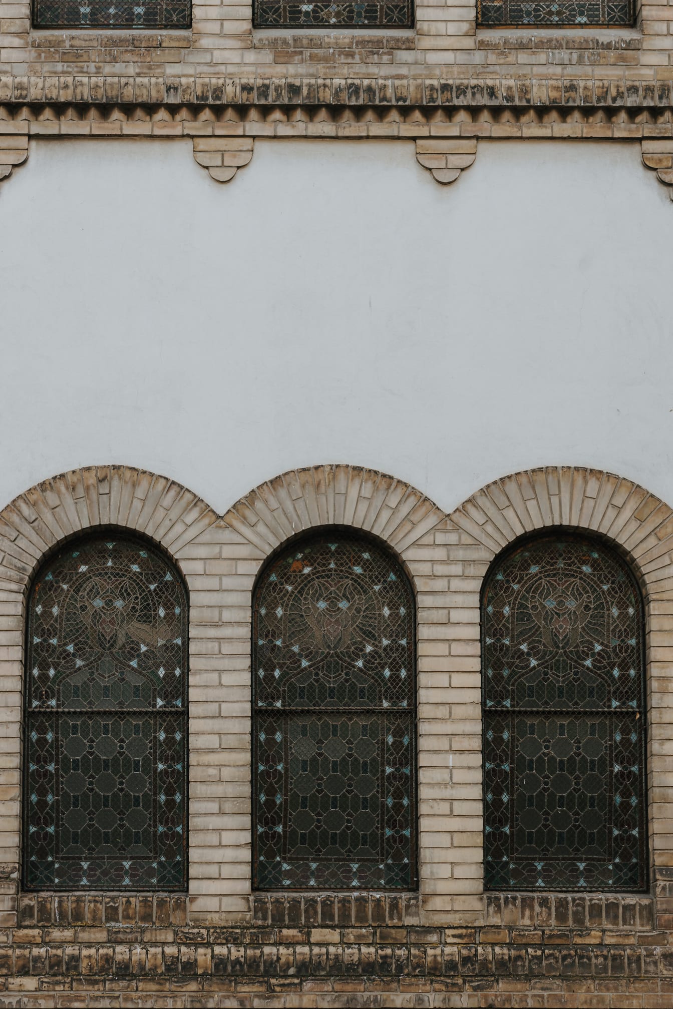 Three stained glass windows with arches