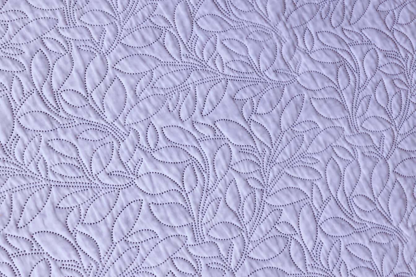 Bright purplish cotton textile with ornamental sewing texture