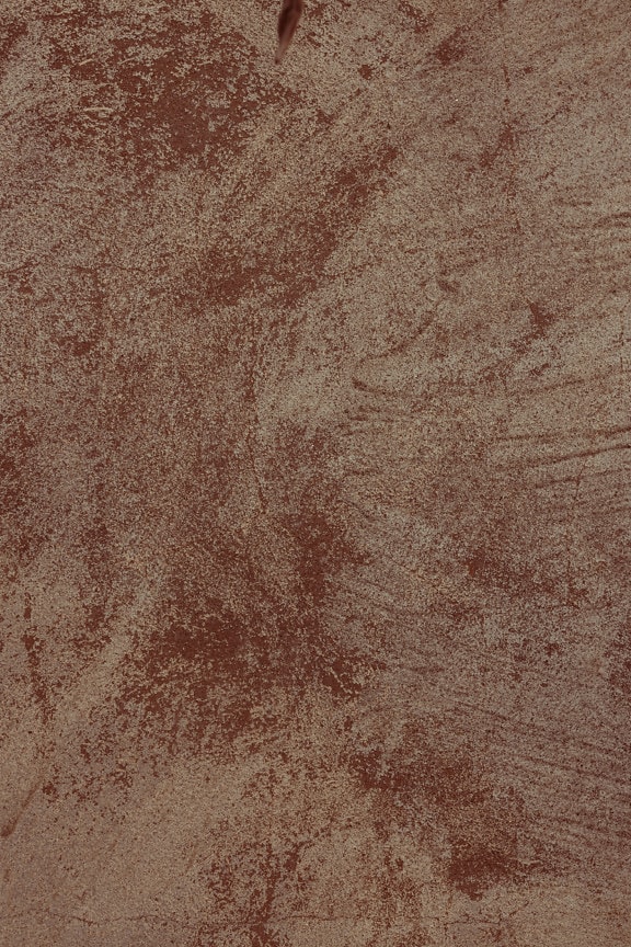 Reddish beige dirty cement surface texture close-up