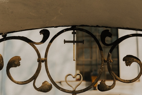 Cast iron cross with heart on handmade fence