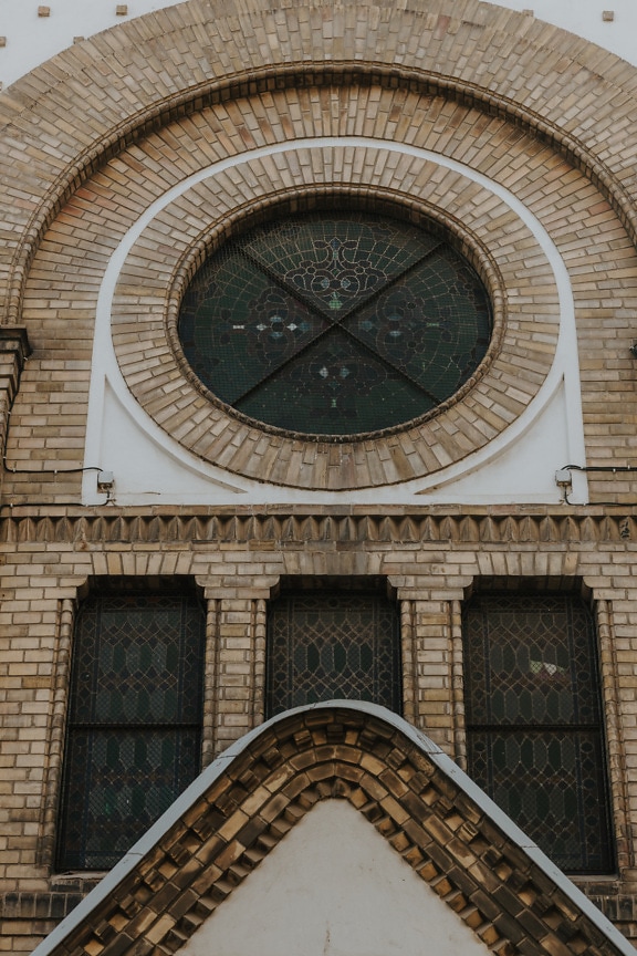 Stained glass round window on synagogue brick wall