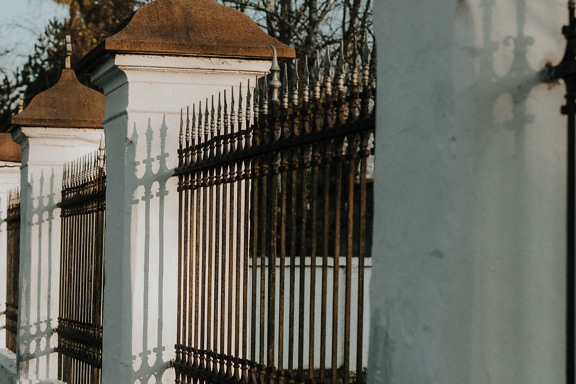 Old style cast iron fence with white columns