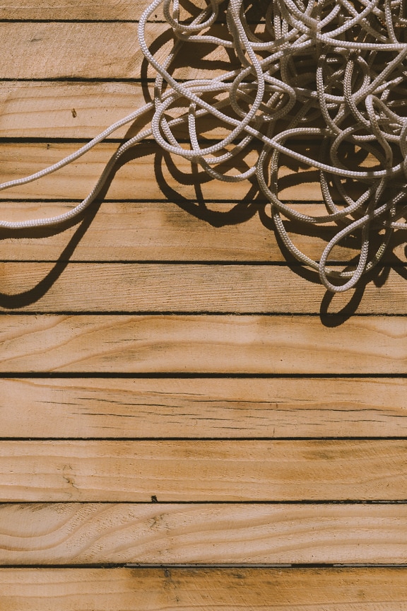 White nylon rope thread on wooden boardwalk