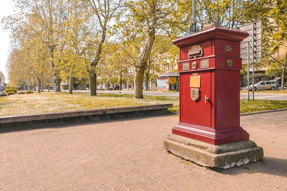 Old antique dark red post mail box on street
