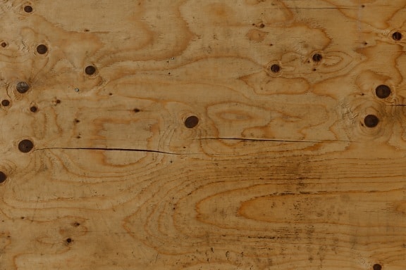 Old rustic brown plank with knot texture close-up