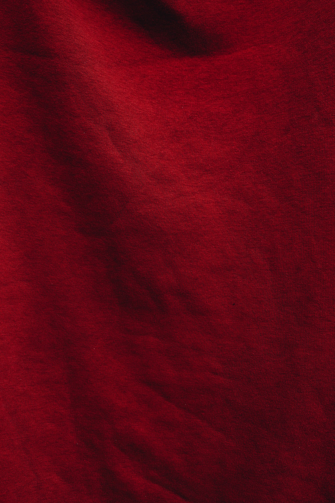 Tecido de algodão vermelho escuro na textura da sombra
