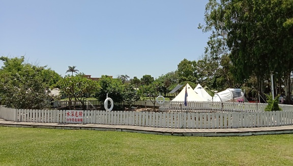 Playground with white picket fence in park