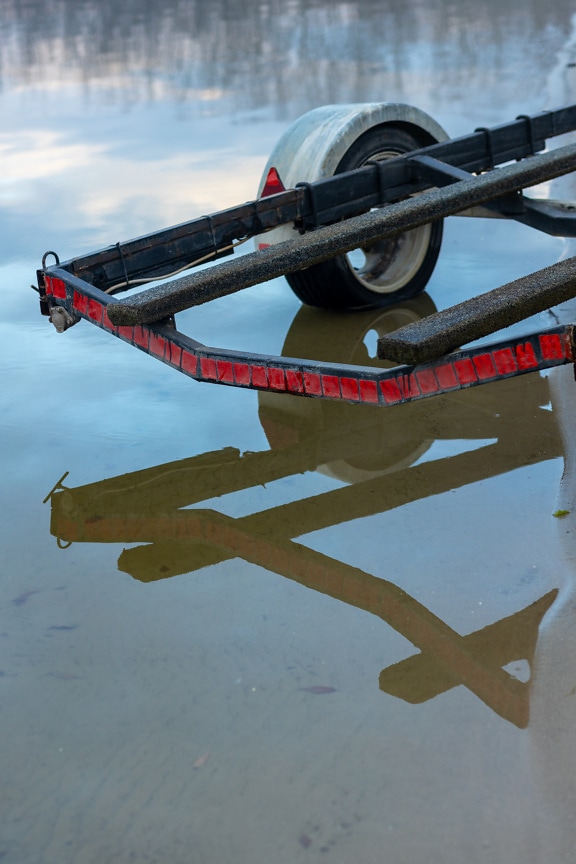 Boat trailer in shallow water close up