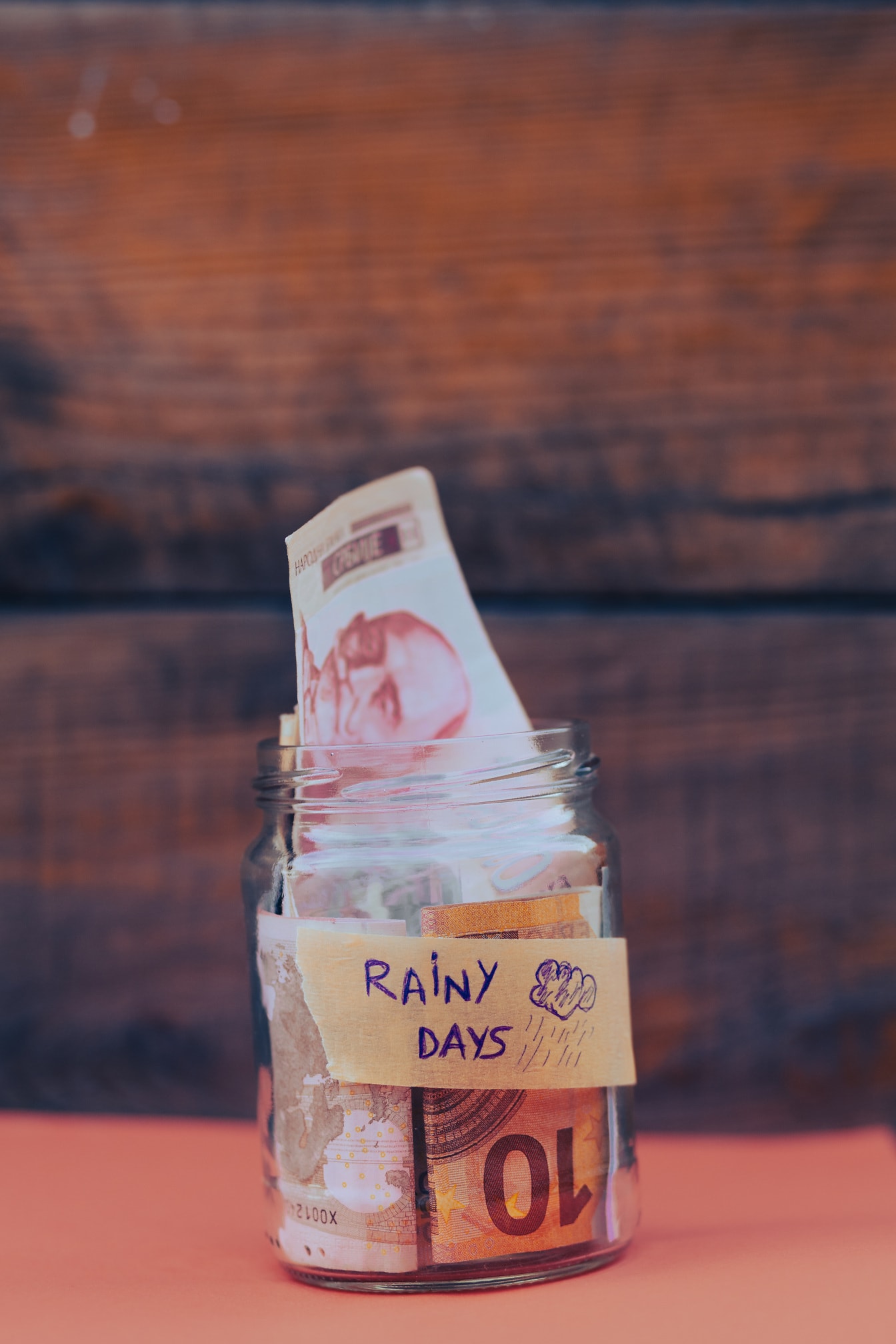 Paper money savings in glass jar for rainy days