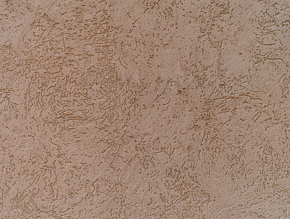 Texture ravvicinata della parete della facciata in cemento beige