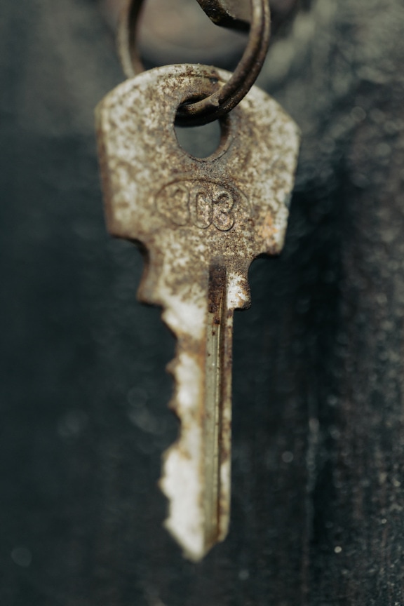 Close-up of old rusty metal key hanging