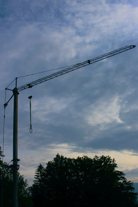 Heavy high industry crane with dark blue sky background