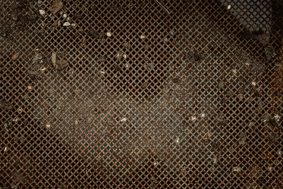 Textúra špinavej hrdzavej priehľadnej železnej mriežky