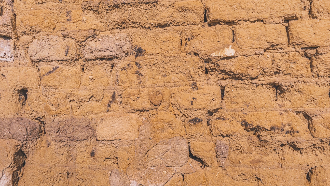 Textura de pared de adobe áspero seco de color marrón claro