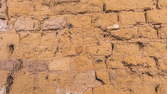 Light brown dry rough adobe brick wall texture