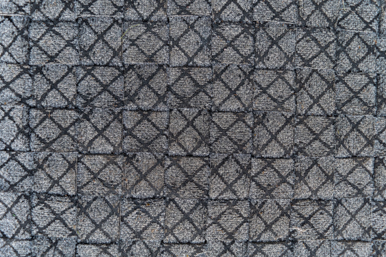 Vuile grijze plastic textuur met geometrisch kubuspatroon