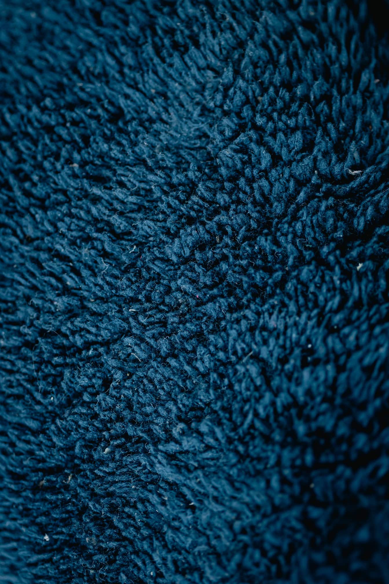 Warna cerah biru tua dari tekstur close-up wol
