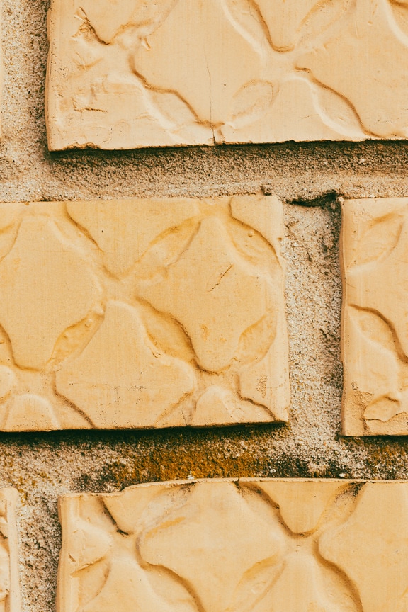 Bright light brown brick wall close-up mortar texture