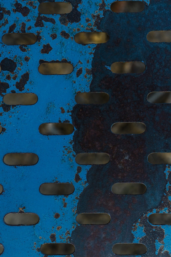 Dark blue paint rust metal texture with geometric hole pattern