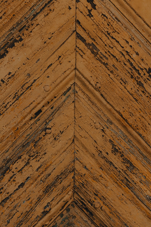 Light brown dry rough paint on planks with diagonal pattern