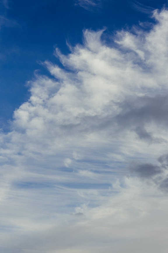 White clouds on bright azure blue sky