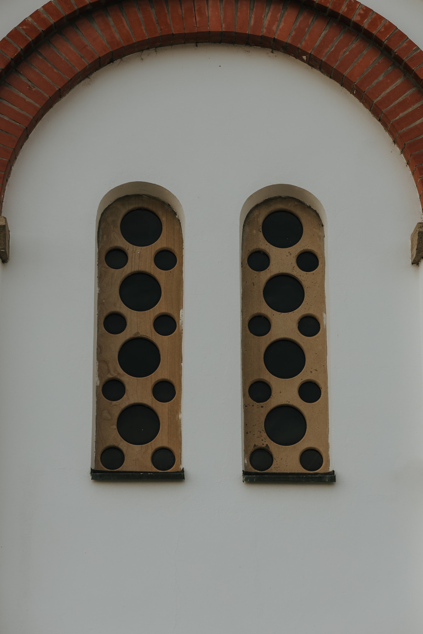 Light brown stonework windows with holes