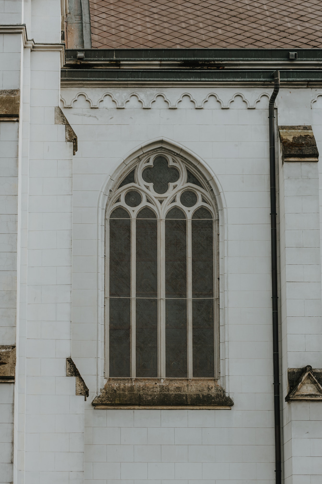 High gothic style stone arch window on cathedral