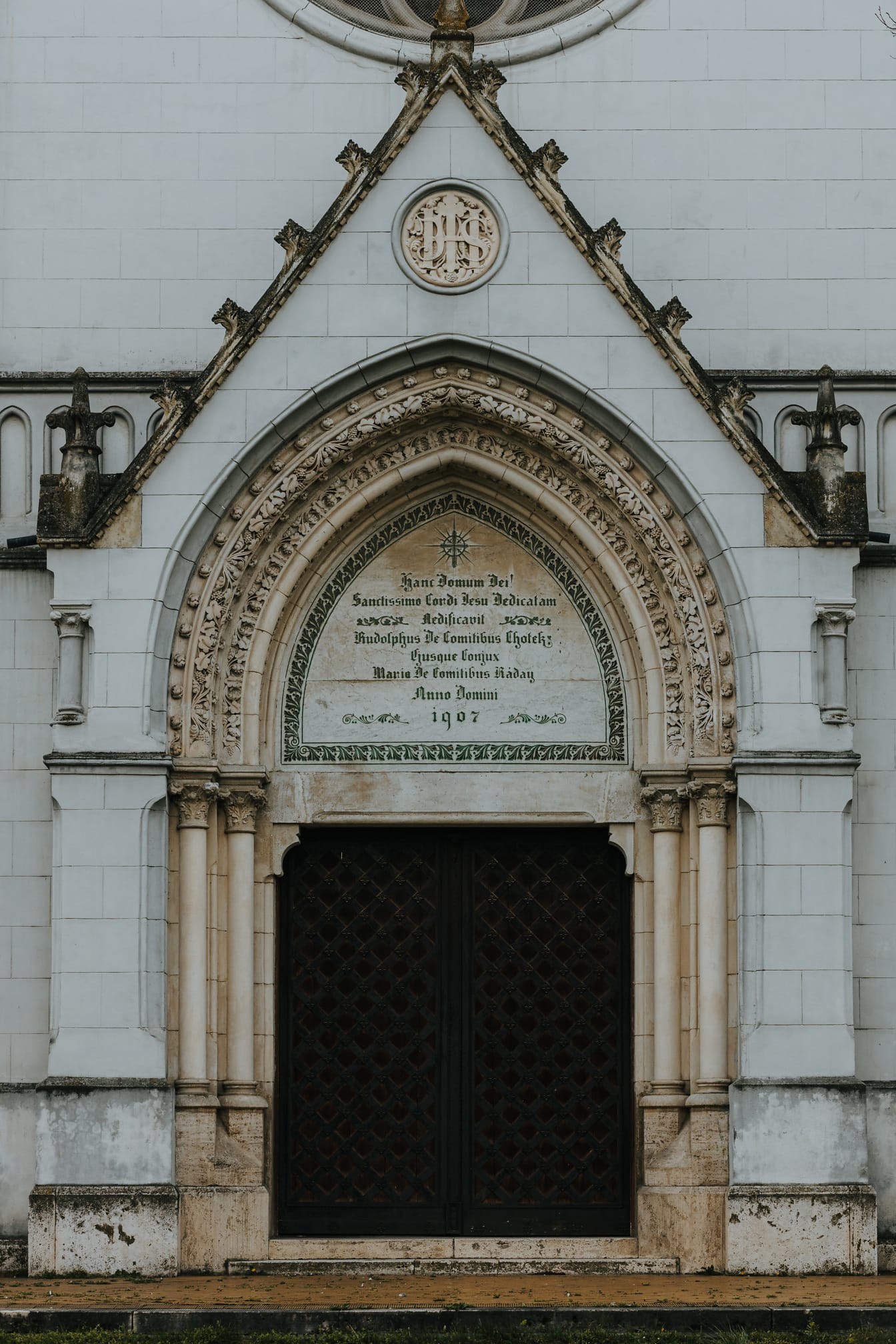 Front door entrance to gothic catholic cathedral with stone arch decoration
