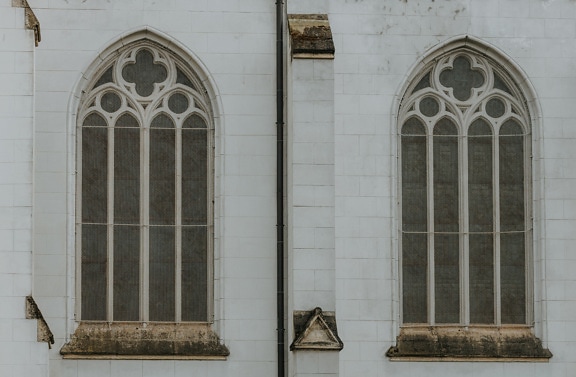 Gothic windows with arch on white marble wall