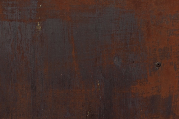 Dark brown rust on iron close-up texture