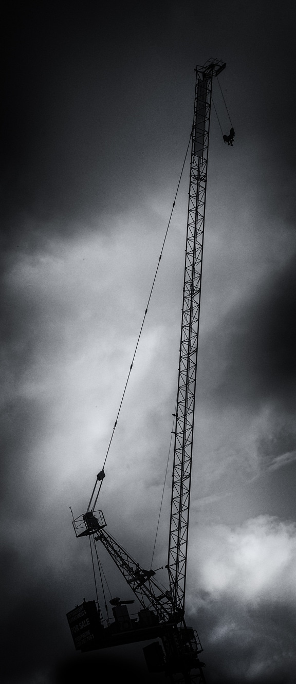 High crane at construction workplace black and white photo