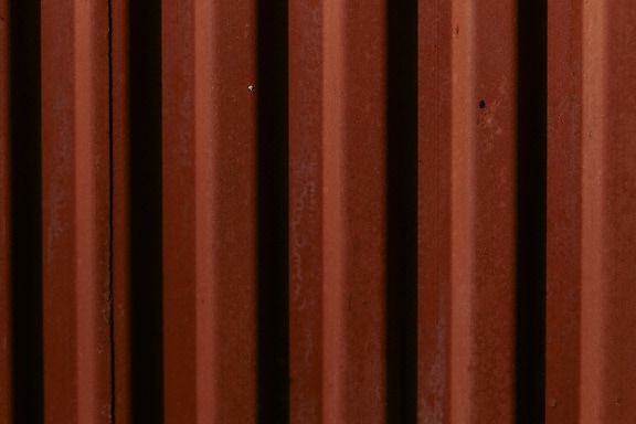 Dark brown rust texture on metal with shadow