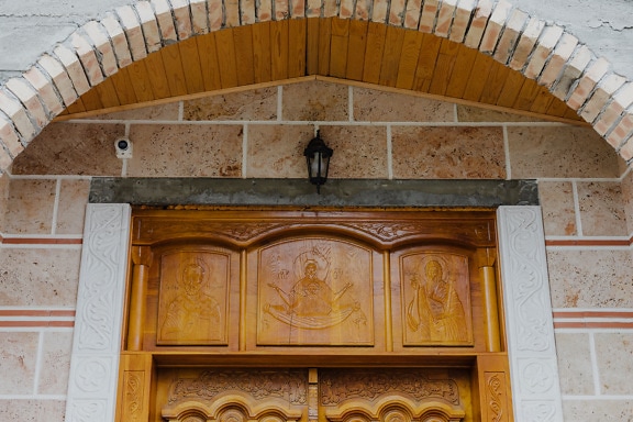 Carved wooden orthodox icons on front door of monastery