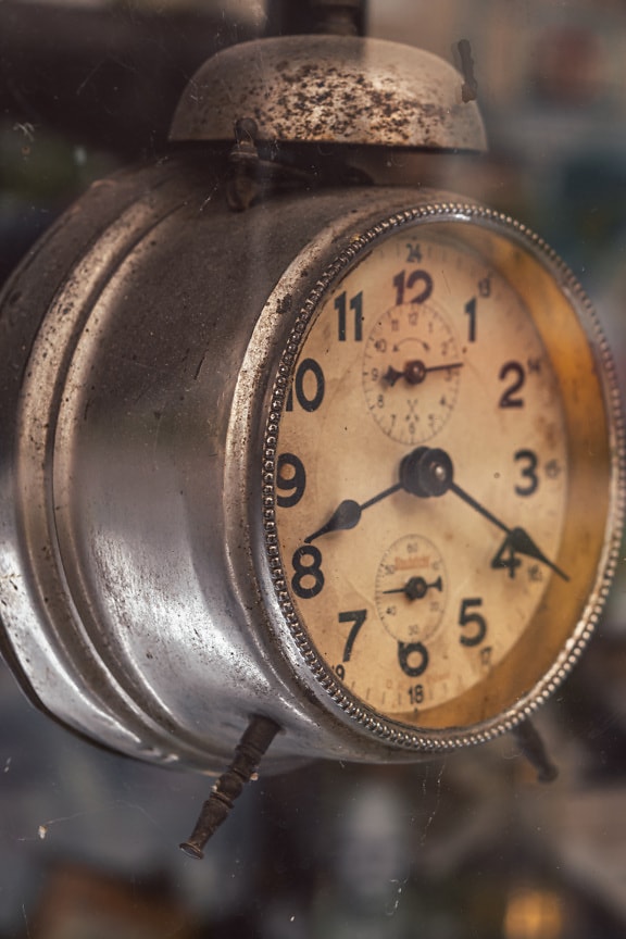 Old style rustic vintage alarm clock close-up