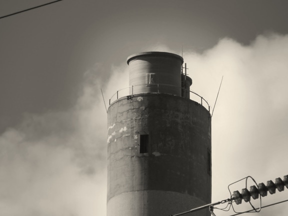 Industrial water tower at electric facility monochrome photo