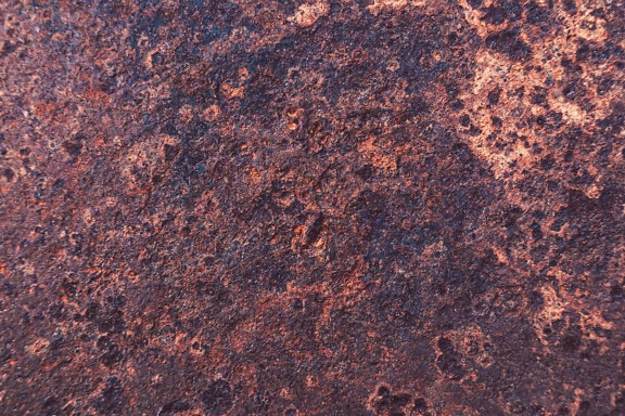 Rough iron surface with rust on metal close-up texture