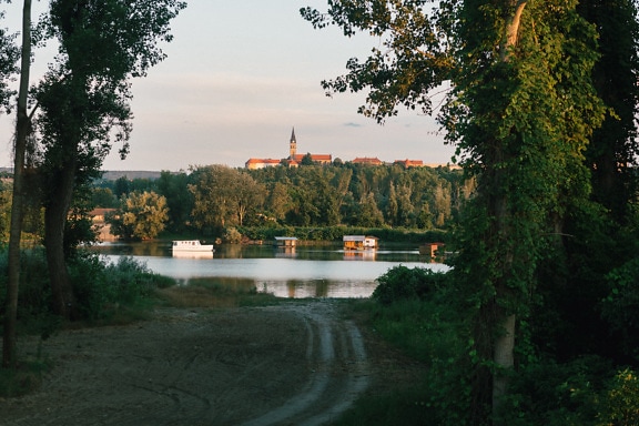 Panoramic view of church tower in distance at Danube riverbank