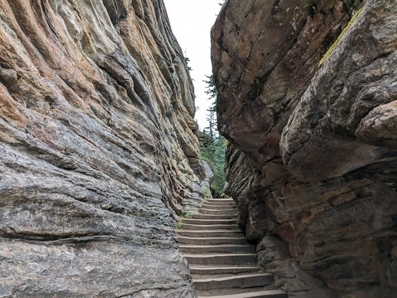 Stone staircase in narrow cliff passage in Canada national park