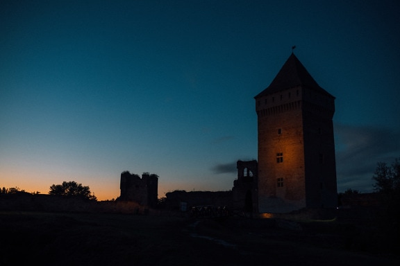 Medieval castle tower illuminated at night
