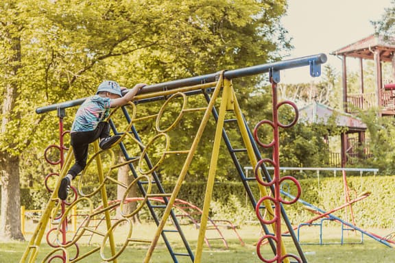 Young boy enjoying climbing in playground