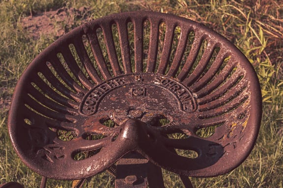 Close-up of cast iron seat of vintage rustic machine
