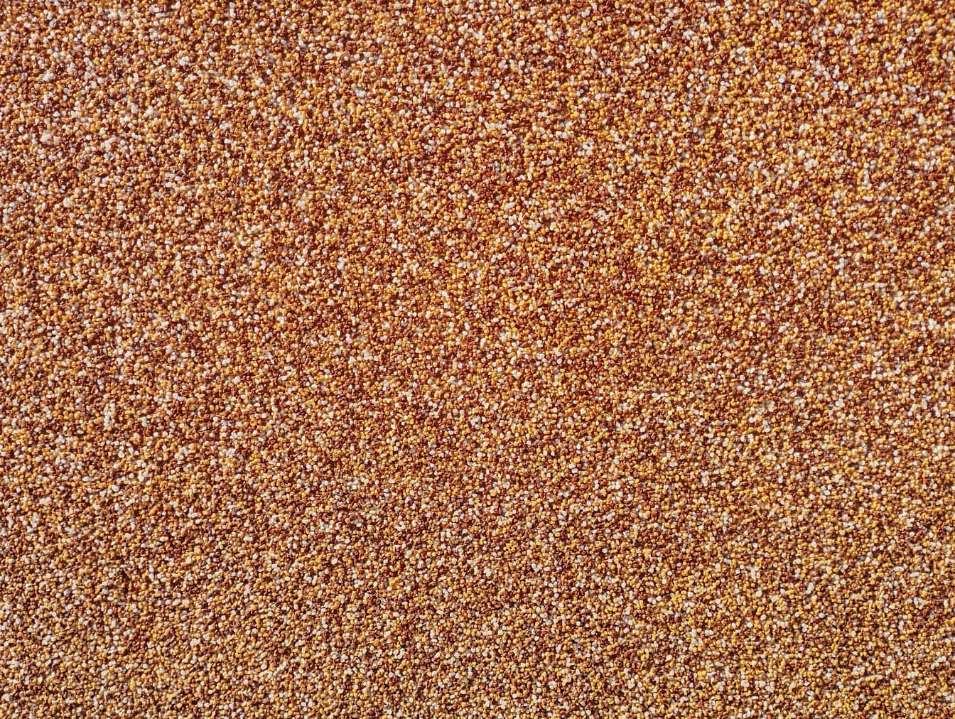 Textura de pequeños guijarros de color marrón amarillento, rojo oscuro y blanco