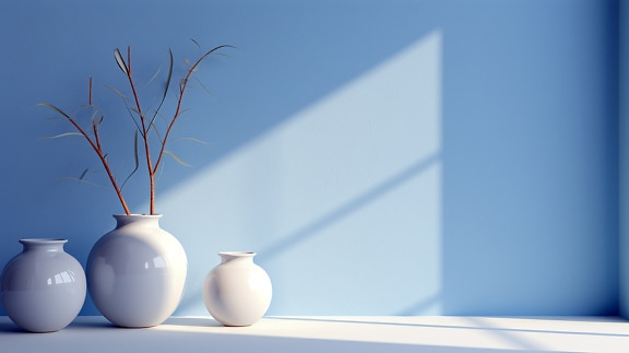 Три сяючі керамічні білі вази на тлі блакитної стіни