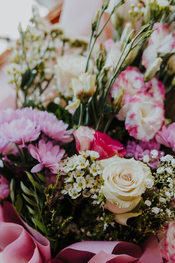 Close-up of beautifull bouquet with pinkish flowers and white roses