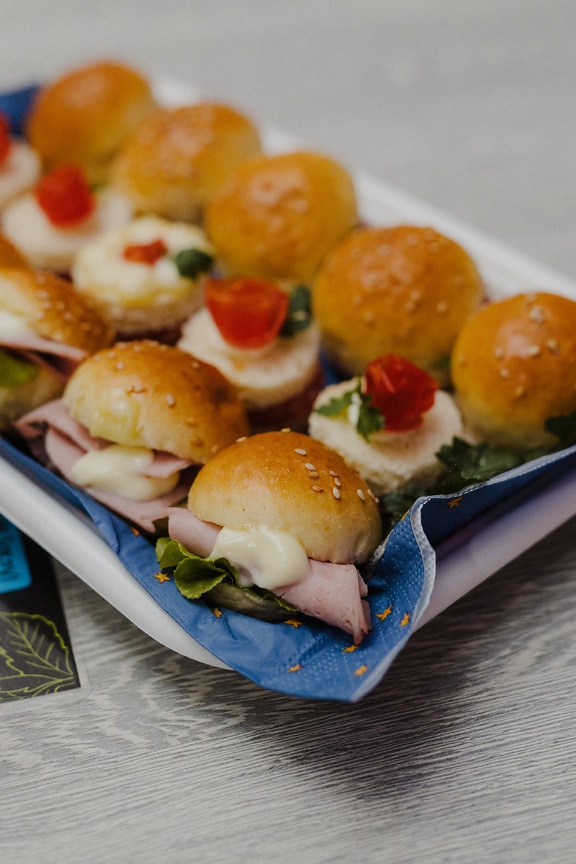 Miniature sandwiches with ham and cheese close-up