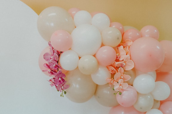Pastel color balloons with pinkish orchid flowers