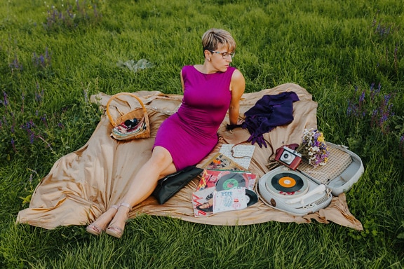 Gorgeous lady siting on picnic blanket nostalgia photo